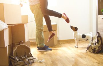 happy couple with dog in new house