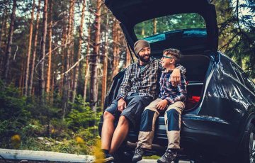 father and son on an adventure in their car